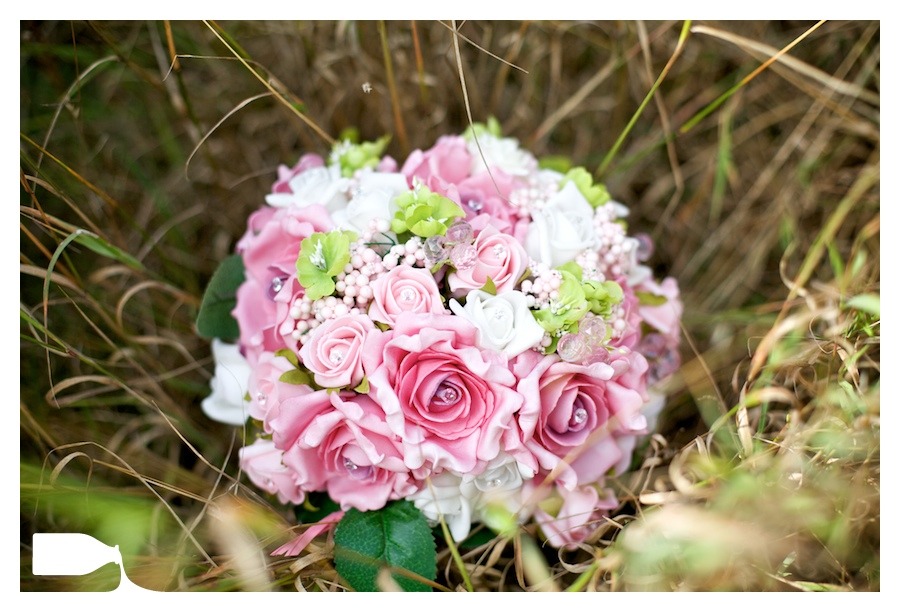 bride flowers on wedding day in long grass